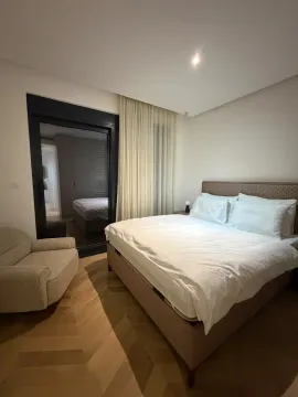 Modern bedroom with a double bed, armchair, and access to the terrace. - image 4