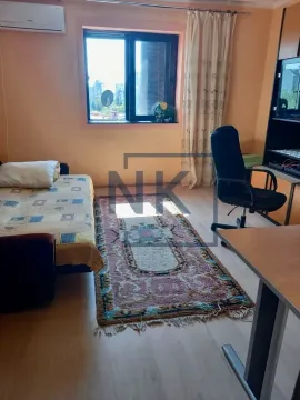 Furnished bedroom with a bed, desk, and air conditioning unit. - image 5