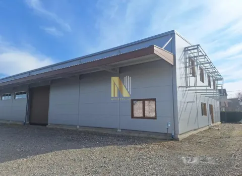Exterior of a modern industrial building with a metal facade and windows. - image 2