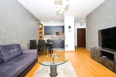 Living room with a dining area and kitchen in the background. - image 3