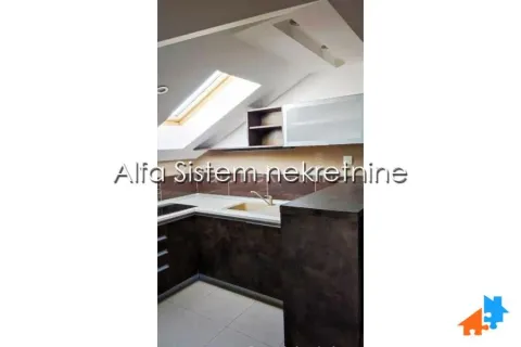 Attic kitchen with a skylight and fitted cabinets. - image 5