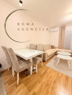 Living room with a dining table and sofa set. - image 3