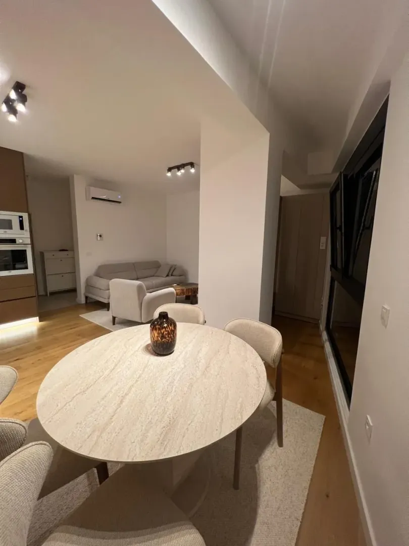 Living room with dining area and kitchen in the background.