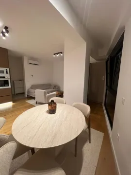 Living room with dining area and kitchen in the background. - image 10