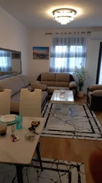 Bright living room with a seating set and a table. - image 3