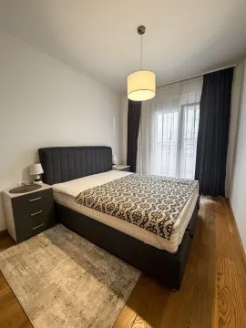 Bedroom with a double bed, bedside tables, and access to the terrace. - image 3
