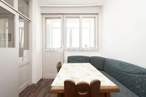 Dining area with a corner seating bench and a table. - image 8