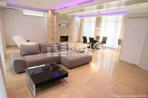 Spacious living room with a sofa and dining area in the background. - image 14