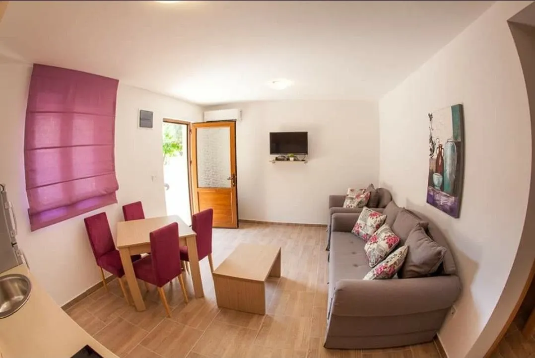 Living room with dining area and sofa set.