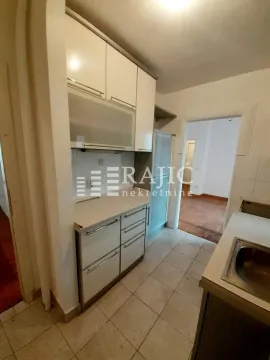 Small kitchen with white cabinets and a sink. - image 9