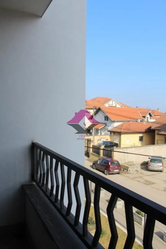 View from the balcony overlooking the street and surrounding houses.