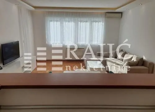 Living room with sofa and TV.