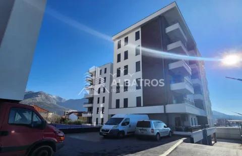 Exterior view of the residential building with parking and surrounding landscape. - image 7