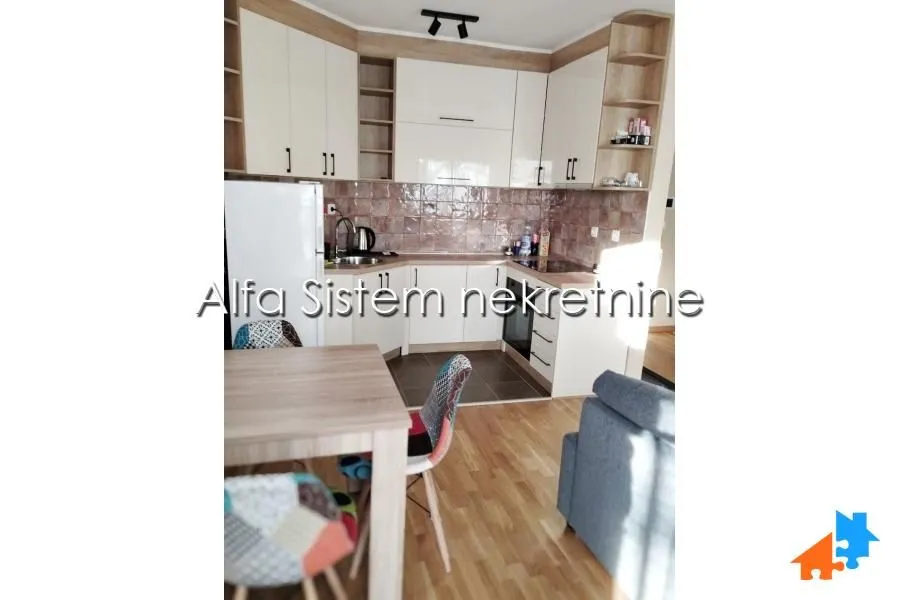 Kitchen with cabinetry and a dining table.
