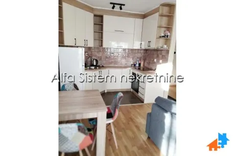 Kitchen with cabinetry and a dining table. - image 8