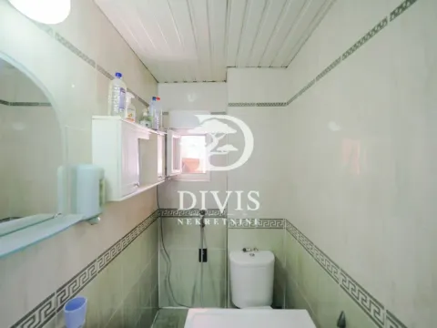 Manje kupatilo obloženo keramičkim pločicama sa toaletom i ogledalom. - image 14