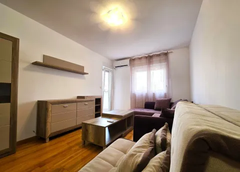 Living room with a sofa set, wooden dresser, and coffee table. - image 3