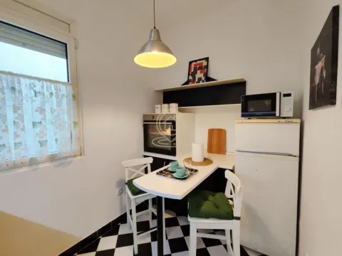 Small kitchen with a dining table and chairs. - image 3