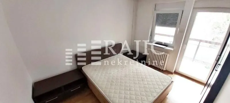 Bedroom with a double bed and balcony access.