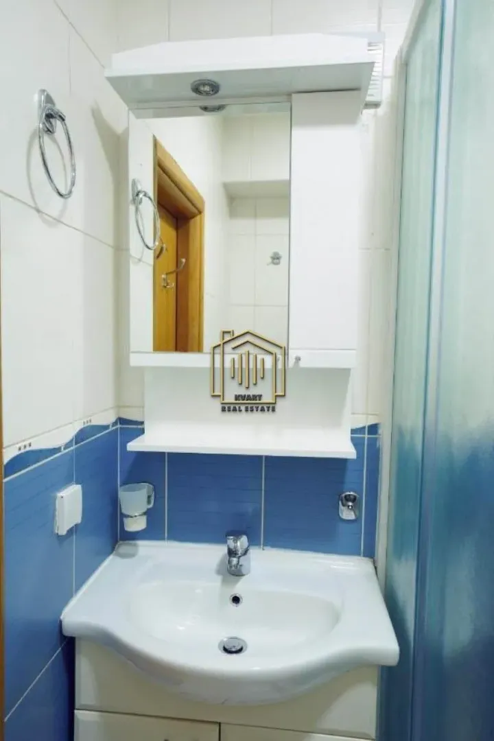 Small bathroom with a sink and a mirror.