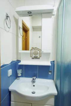 Small bathroom with a sink and a mirror. - image 9