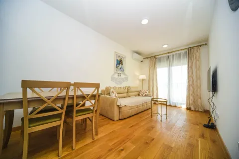 Living room with dining area, sofa and wooden floor. - image 2