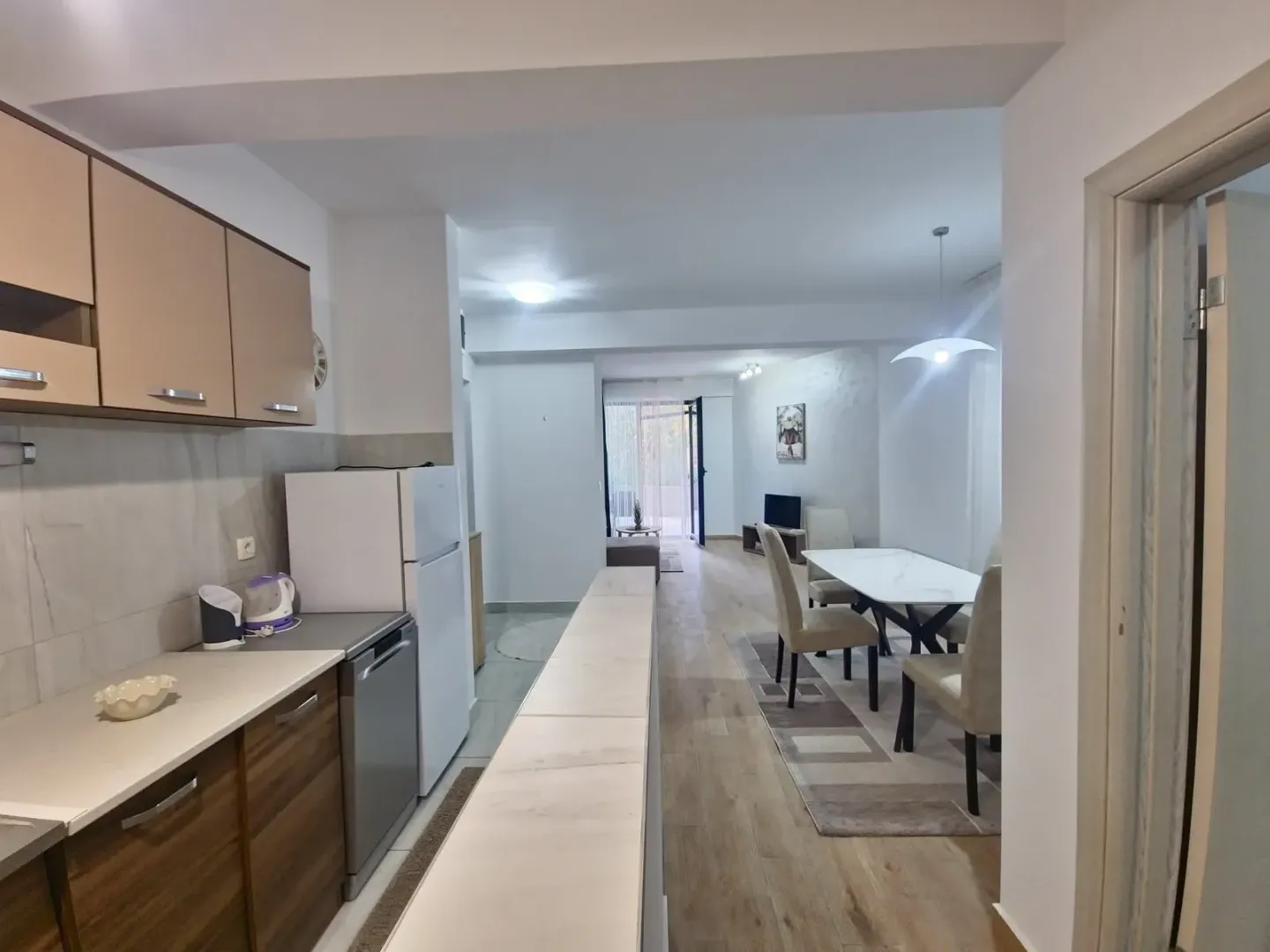 View from the kitchen towards the dining area and living room in the apartment.