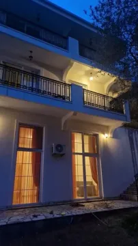 View of the exterior of a multi-story house with terraces in the evening. - image 4