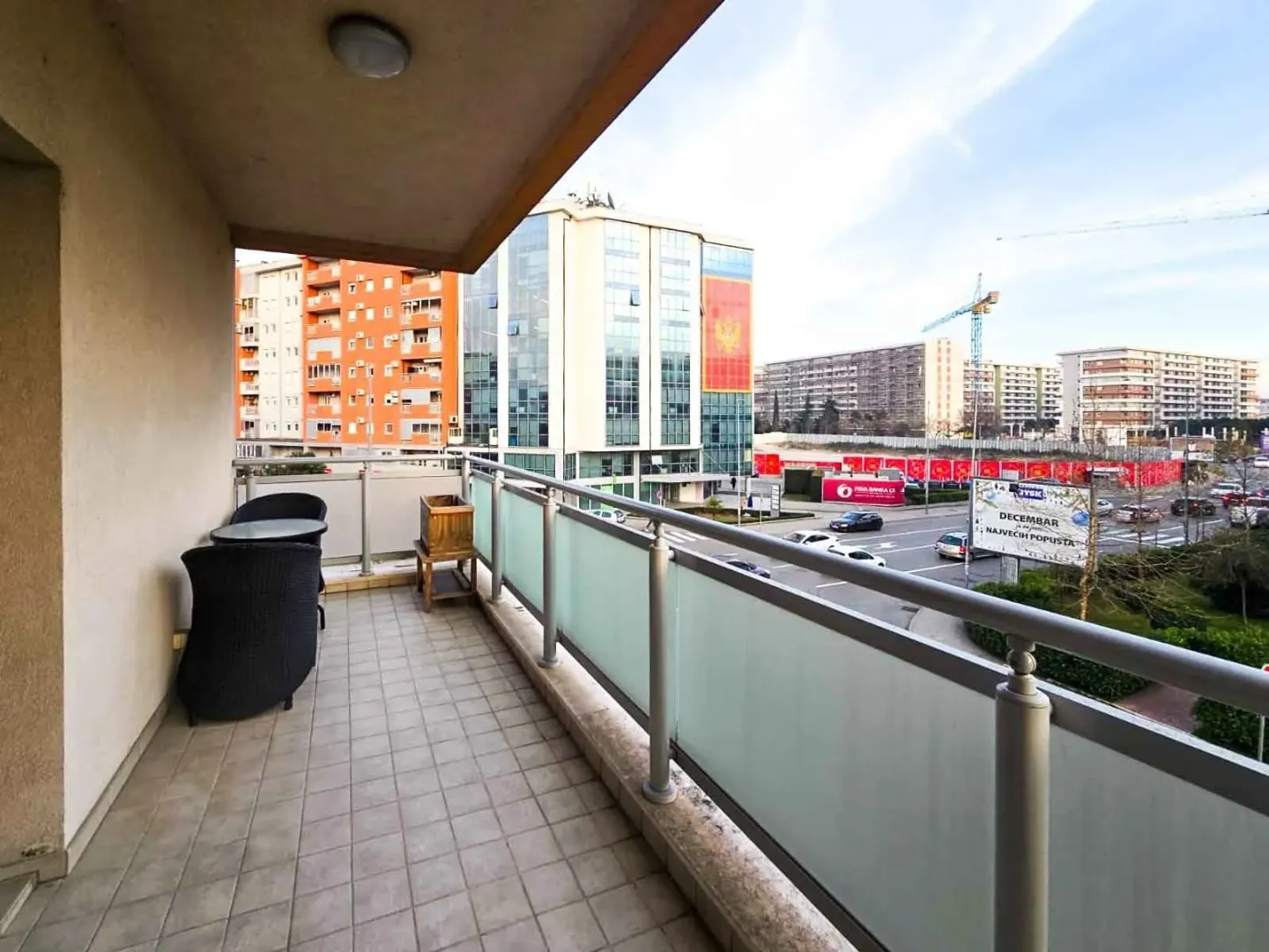 Spacious terrace with outdoor furniture and a city view.