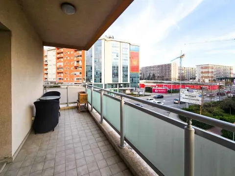 Spacious terrace with outdoor furniture and a city view. - image 8