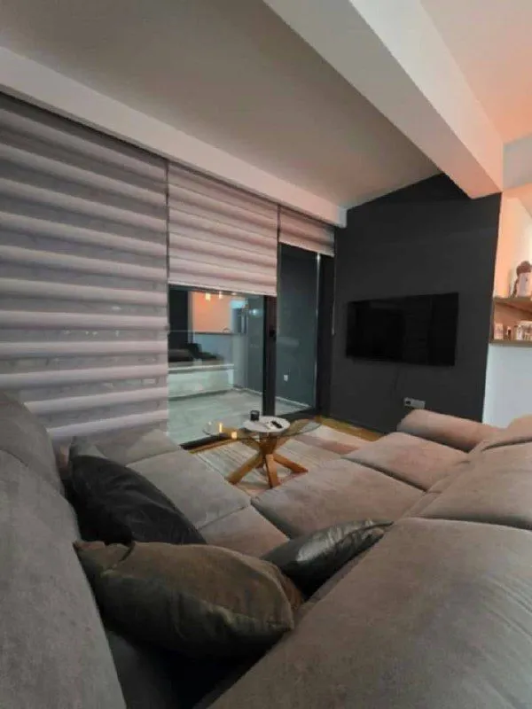 Modern living room with a sofa and TV.