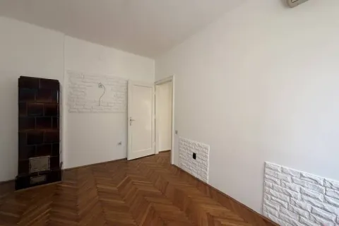 Empty room with parquet flooring and a wood stove. - image 13