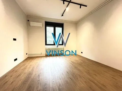 Empty room with laminate flooring, white walls, and an air conditioning unit. - image 2
