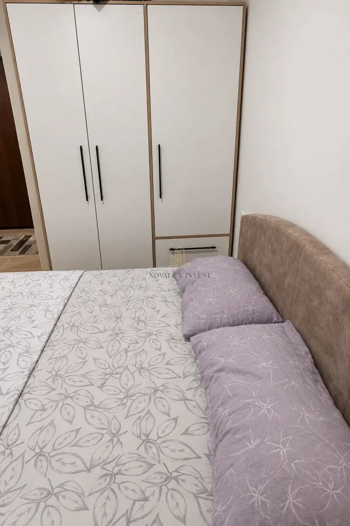 Bedroom with a double bed and a built-in wardrobe.