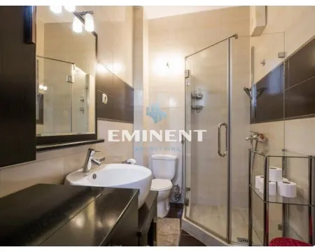 Bathroom equipped with a washbasin, toilet, and a glass-enclosed shower cabin. - image 10