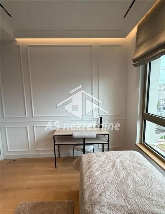 Small bedroom with a bed and a desk by the window.