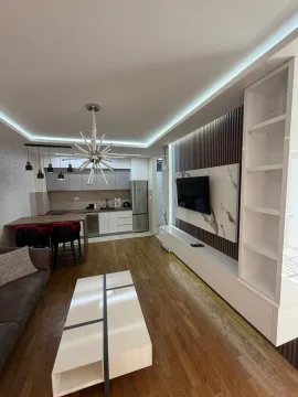 Modern living room with dining area and built-in units. - image 13