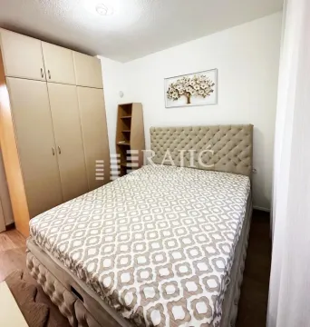 Bedroom with a double bed, wardrobe, and framed picture on the wall. - image 3