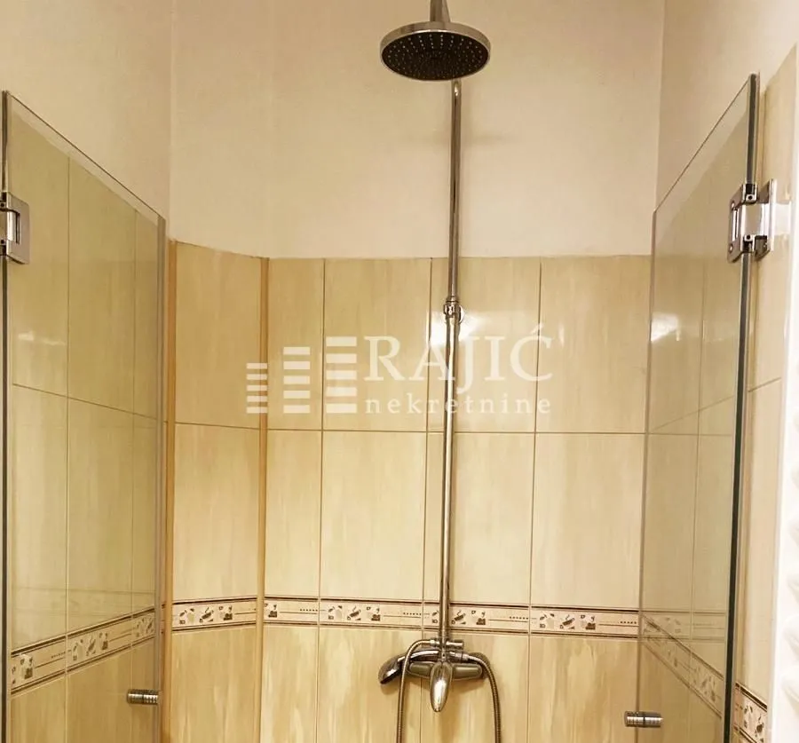 A modern bathroom equipped with a shower cabin.