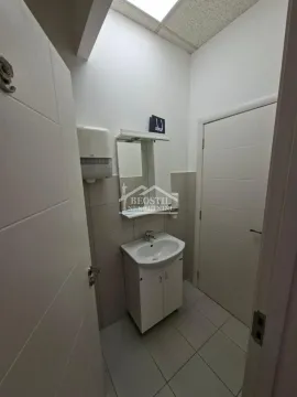 Smaller bathroom with a sink, mirror, and tiles. - image 17