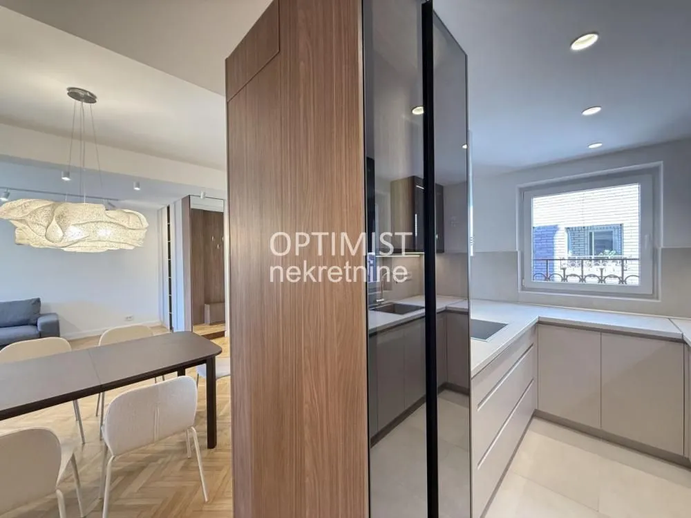 View of a modern equipped kitchen and dining area with wooden elements.
