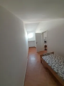 Smaller bedroom with a bed and tiled floor. - image 17