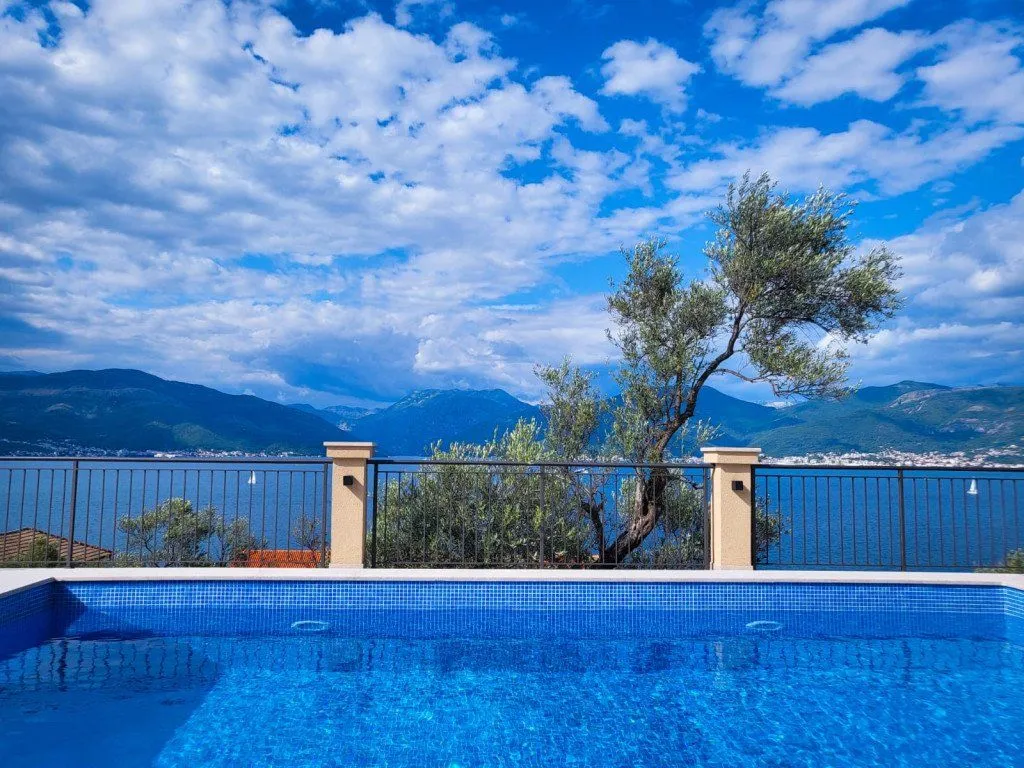 Swimming pool with a view of the sea and mountains.