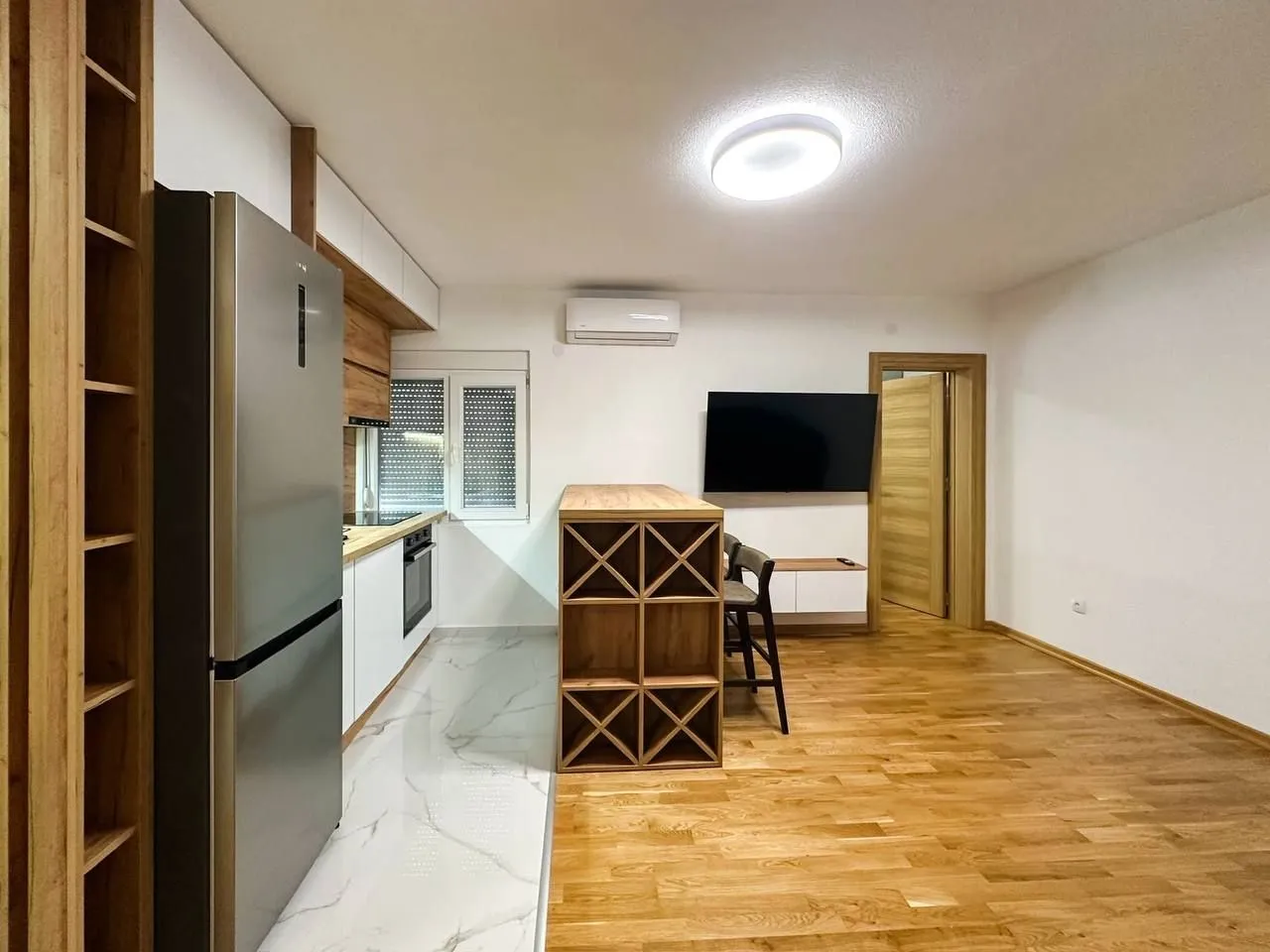 Modern kitchen connected to the dining and living area.