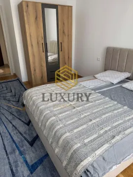 Furnished bedroom with a double bed and a wardrobe. - image 4