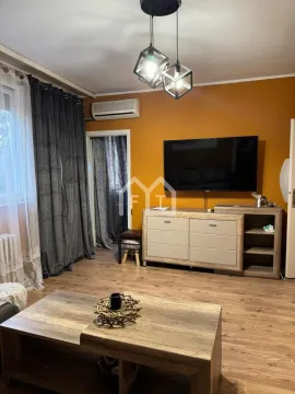 Living room with a TV, chest of drawers, and wooden flooring. - image 5