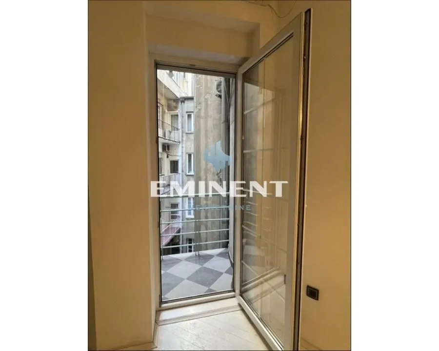 View through the open balcony door toward the exterior of the building.