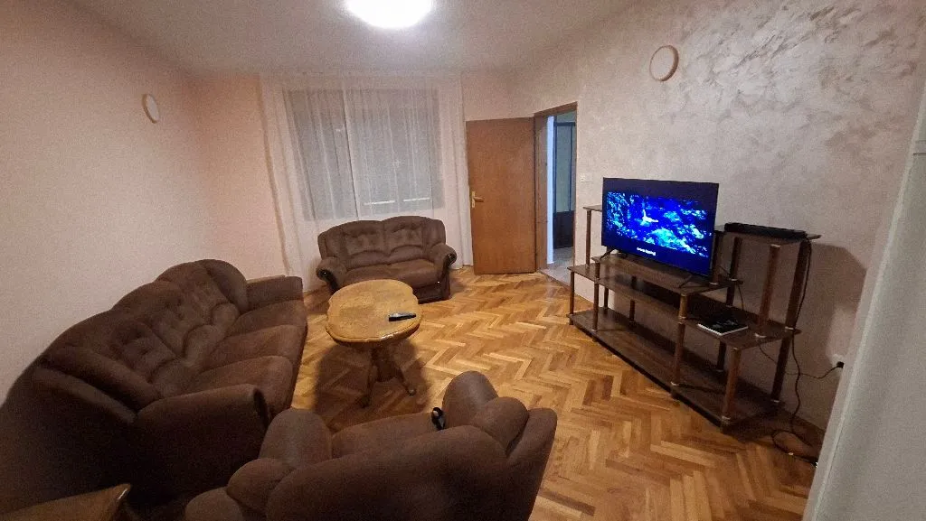 Living room with a sofa set, coffee table, and TV.