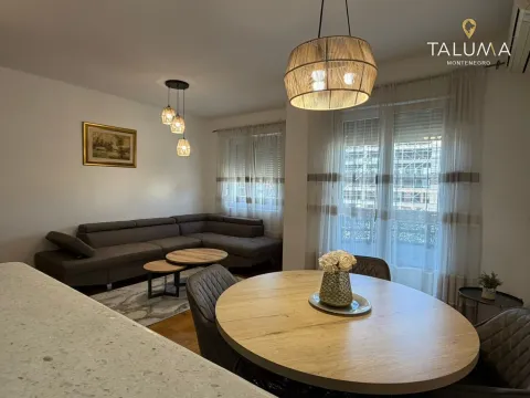 Living room with a sofa and dining table. - image 2