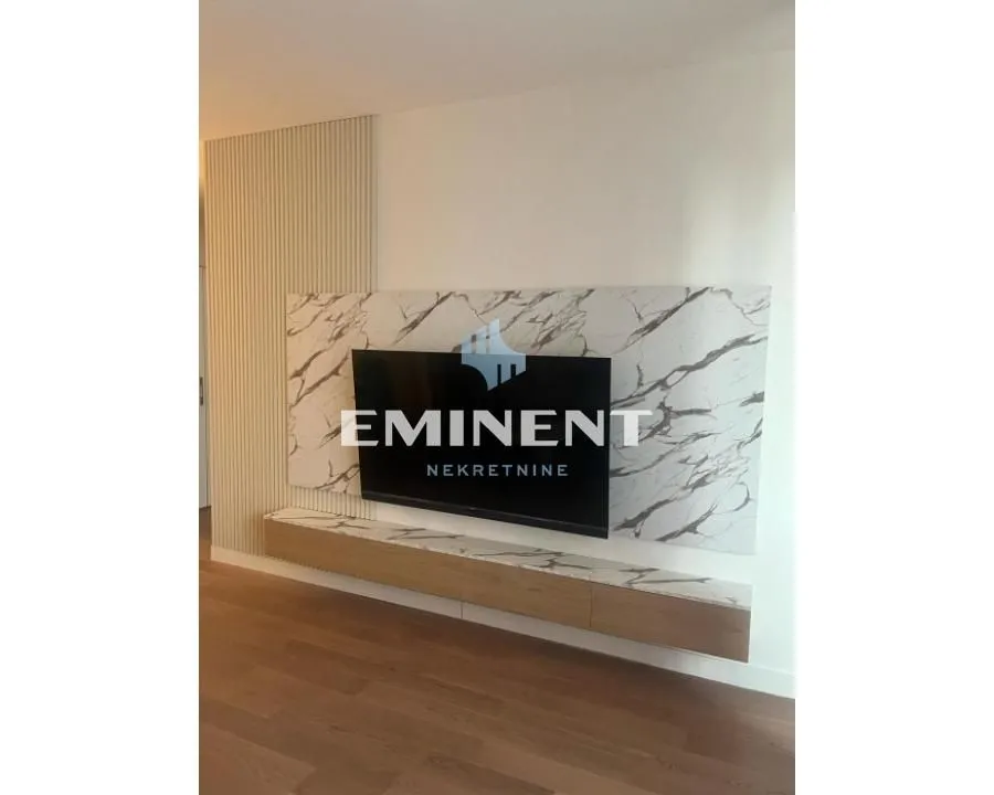 Living room with TV unit and wall panels.